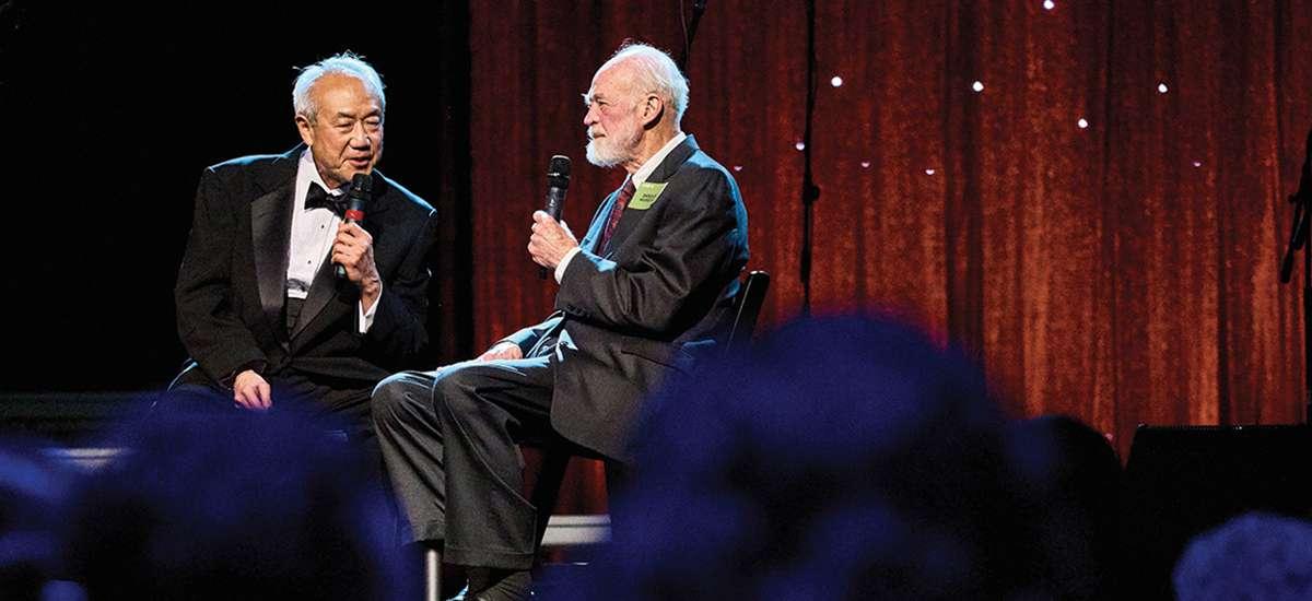 66岁的斯基普·李(右)在晚会上采访了54岁的尤金·彼得森，他是《好的赌博软件推荐》的作者